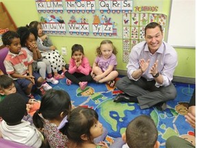 Service Alberta Minister Deron Bilous, right, met with children and their parents at the Centre Day Care in downtown Edmonton on July 30, 2015 to talk about raising a family and popular baby names in Alberta. The top baby names in Alberta in 2014, where 55,587 babies were born, were Liam and Olivia.