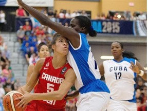 Kia Nurse of Canada is fouled by Arlety Povea Chacon of Cuba during a FIBA Americas Women’s Championship basketball game at the Saville Community Sports Centre on Aug. 13, 2015.