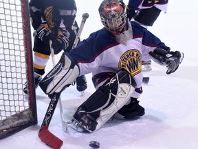 Creepers goalie Kareem Johma watches the puck deflect to the corner during a novice hockey game at Oliver Arena between the Hawks Athletic Club and the Whitemud West Creepers.