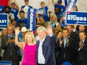 Stephen Harper, with his wife Laureen, delivers campaign remarks at a Conservative Party rally at Packers Plus in Edmonton on Wednesday, Aug. 12, 2015.