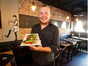 Stephen Sicoli of Tapavino shows off a hummus pizza, one of reviewer Mariam Ibrahim’s favourite choices during her recent visit to the new downtown tapas restaurant.