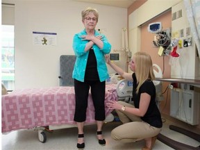 Susan Gokiert demonstrates a sit stand exercise with Aly McComb, exercise physiologist. Getting elderly patients home sooner, stronger and with fewer complications after emergency general surgery is the goal of an elder-friendly emergency surgical unit now being created at University of Alberta Hospital. It is called EASE, Elder-Friendly Approaches to the Surgical Environment.