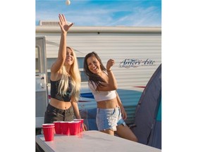 Taylor Langer (left) and Skylar Laboucan compete in a friendly game of beer pong on day two of Big Valley Jamboree 2015 in Camrose on July 31, 2015.
