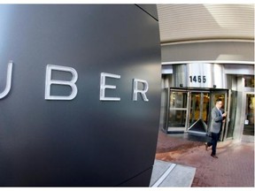 In this Dec. 16, 2014, file photo a man leaves the headquarters of Uber in San Francisco.