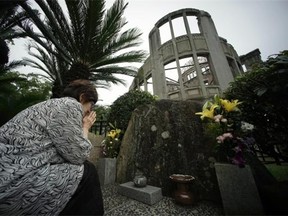 In this July 3, 2015 photo, Kimie Mihara, a survivor of the 1945 atomic bombing, prays at the cenotaph at the Atomic Bomb Dome, as it is known today in Hiroshima, Hiroshima Prefecture, southern Japan.