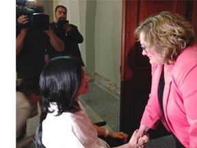 Vicky Venancio and Health Minister Sarah Hoffman share a moment after meeting July 16 to discuss immigration and health issues for the injured temporary foreign worker.