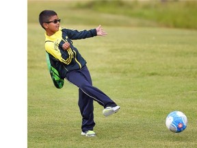 Vinodh Sundararajah, 8, chips the ball toward the pin during a game of footgolf at the Rundle Park Golf Course on July 17, 2015.