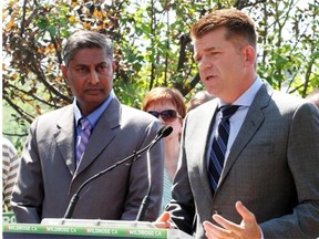 WIldrose Leader Brian Jean, right, talks to Calgarians about the issues facing voters this byelection as Calgary-Foothills candidate Prasad Panda looks on in this photo taken Aug. 13, 2015.