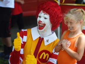 Six-year-old Kaitlynn Banman meets Ronald McDonald during the 3rd annual RMHCNA Block Party in Edmonton on Sunday July 26, 2015.