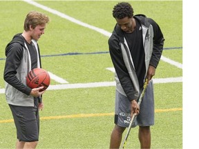 Canadian athletes Connor McDavid, left, 2015 First Overall NHL Draft Pick and Andrew Wiggins, 2015 NBA Rookie of the Year, joke around trading their stick and basketball respectively during a break in shooting a BioSteel sports drink commercial in Toronto on Tuesday, August 4, 2015.