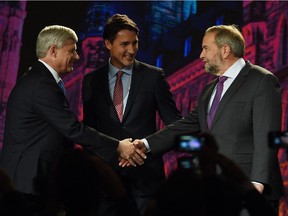 NDP leader Tom Mulcair shakes hands with Conservative leader Stephen Harper as Liberal leader Justin Trudeau looks on during their introduction prior to the Globe and Mail hosted leaders' debate in Calgary on Thursday, September 17, 2015.  THE CANADIAN PRESS/Sean Kilpatrick