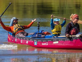 Benoit Gendreau-Berthiaume, left, and Magali Moffatt and their five year-old son Mali arrive in Montreal after their 5,000 kilometres canoe trip from Edmonton on Saturday, Sept. 26, 2015.