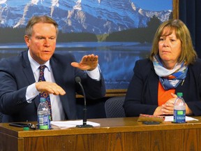 Alberta Energy Minister Marg McCuaig-Boyd, right, and Dave Mowat, the president and CEO of ATB Financial, take questions in the legislature media room after McCuaig-Boyd announces Mowat will head up a review of Alberta's oil and gas royalty structure in Edmonton, Friday, June 26, 2015. The NDP government says it wants to make sure Albertans are getting a fair return on profits from the the oil and gas sector.