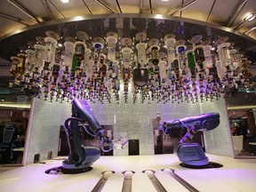 Robot bartenders wait for a customer onboard the cruise ship Quantum of the Seas.