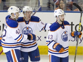 Edmonton Oilers' Anton Slepyshev (42), Connor McDavid (97) and Alexis Loiseau (43) celebrate a goal against the University of Alberta Golden Bears during first period exhibition hockey action as the Oilers rookies take on the university team in Edmonton, Alta., on Wednesday September 16, 2015.