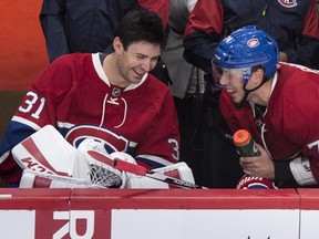 Montreal Canadiens' goalie Carey Price, left, shares a laugh with teammate Alexei Emelin while sitting on the bench as they face the Toronto Maple Leafs during second period NHL pre-season hockey action Tuesday, September 22, 2015, in Montreal.