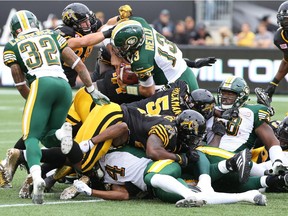 Edmonton Eskimos quarterback Mike Reilly (13) carries the ball during the first half of the game against the Tiger-Cats in Hamilton on Saturday, Sept. 19, 2015.