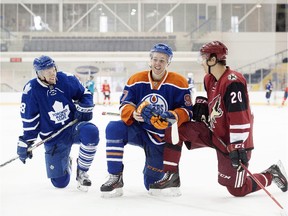 From left to right, Toronto Maple Leafs' Connor Brown, Edmonton Oilers' Connor McDavid, and Arizona Coyotes' Dylan Strome take a break during the NHLPA Rookie Showcase in Toronto on Sept. 1, 2015.