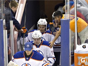 Edmonton Oilers' Connor McDavid (97) walks onto the ice as a fan reaches for him, while playing against the University of Alberta Golden Bears during third period exhibition hockey action as the Oilers rookies take on the university team in Edmonton, Alta., on Wednesday September 16, 2015.
