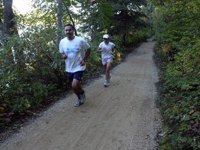 Joggers run the trail between Kinsmen and Emily Murphy parks.