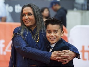 Deepa Mehta, left, embraces Samir Amarshi as they pose for photos on the red carpet at the gala for the film "Beeba Boys," at the 2015 Toronto International Film Festival in Toronto on Sunday, Sept. 13, 2015.