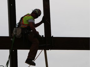 Construction workers continue work on the structural steel framework of the National Music Centre in Calgary on Friday May 23, 2014.