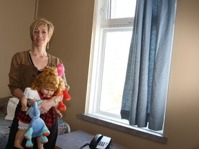 In this May 27, 2009 file photo, Arlene Adamson, chief operating officer of the YWCA of Calgary, stands inside one of the rooms available for women in need of a place to stay. The YWCA does effective work helping women along the long road from leaving a violent home life to making a stable, economically functioning, safe life for themselves and their children.