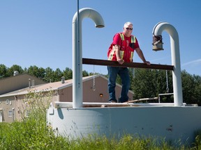 Bill Adams, utilities manager for the town of Drayton Valley poses for a photo outside the old water treatment plant in Drayton Valley, Alta. on July 30, 2015.