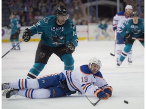 EDMONTON, AB. APRIL 9, 2015 -Justin Schultz (19)of the Edmonton Oilers, falls and gives the puck away to Patrick Marleau (12) of the San Jose Sharks at Rexall Place in Edmonton. Shaughn Butts/Edmonton Journal