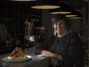 Andrea Olsen, co-owner of Canteen, with a dish of chicken and waffles