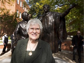 Edmonton artist Barbara Paterson stands in front of her sculpture of Henry Marshall Tory and Alberta's first premier, Alexander Rutherford, after the unveiling of the monument on Sept. 24, 2015, in Edmonton.