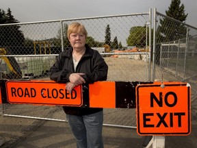 Irene Blain stands in front of a broken sewer pipe that has strong doors coming from it on August 25, 2015 in Edmonton. It comes in wafts, often waking residents in the middle of the night and causing nausea so bad some have vomited.