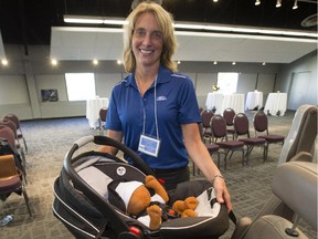 Kelley Adams-Campos, a child passenger safety technician who helped write Ford's owners manual for child restraints, demonstrates the proper us of child seats on Sept. 23, 2015, at the Telus World of Science in Edmonton.