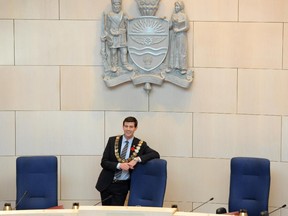 EDMONTON, AB. - OCTOBER 29, 2013  -  Mayor Iveson poses with his new chair under the city of Edmonton coat of arms.  Swearing in ceremony for new Mayor Don Iveson and city councillors, featuring speech by Iveson. Then new council has first meeting, a brief organizational event. Edmonton's 35th Mayor and 12 City Councillors will officially be sworn in. Justice D.M. Manderscheid will administer the official oaths of office. Shaughn Butts/Edmonton Journal