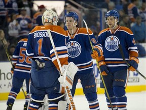 Connor McDavid congratulates goaltender Laurent Brossoit after the Edmonton Oilers defeated the Calgary Flames 4-2 in an NHL pre-season game at Rexall Place on Sept. 21, 2015.