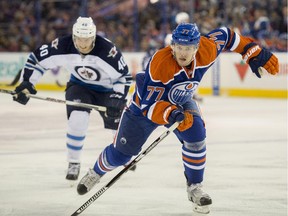 Oscar Klefbom (77) of the Edmonton Oilers drives the puck down the ice with Winnipeg Jets' Joel Armia (40) on his heels in a Sept. 23, 2015, pre-season game at Rexall Place.