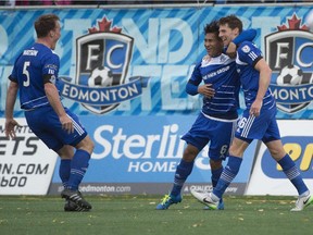 Albert Watson, left, joins the FC Edmonton goal celebration with Dustin Corea and Daryl Fordyce, right, after Fordyce scores the Eddies second goal against  the New York Cosmos at Clarke Field on Sept. 27, 2015.