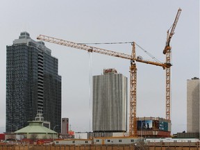 Construction cranes are pictured in downtown Edmonton on April 14, 2015.