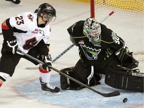 Edmonton Oil Kings goalie Tristan Jarry (right) makes a save against Calgary Hitmen Travis Sanheim (left) during first period WHL hocky game action in Edmonton on March 7, 2015.