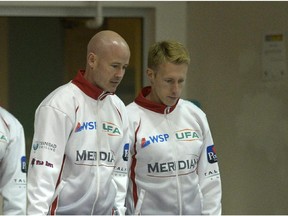 Marc Kennedy, right, discusses strategy with skip Kevin Koe during a team curling practice at the Saville Community Sports Centre in October 2014.