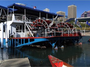 Competitors paddle past downtown and the Edmonton Queen riverboat in this Sept. 11, 2014 file photo.