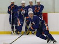 Connor McDavid starts a drill while other Edmonton Oilers rookies watch from the boards during a practice at the Royal Glenora Club on Sept. 15, 2015.
