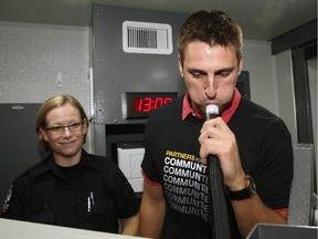 Labatt's employee Darren Kachkowski (right) takes a breathalyzer test with assistance from Edmonton Police Service (EPS) Constable Kathy Nelson inside the EPS Checkstop unit at Labatt's Brewery in Edmonton on September 18, 2015.