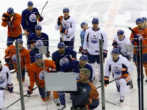 Edmonton Oilers head coach Todd McLellan (foreground) works with players during a pre-season team practice in Edmonton on Sept. 22, 2015.