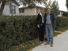 Gail and Roger Black in front of their home in the neighbourhood of Hazeldean in south Edmonton. They were not impressed with the quality of work from the contractors reconstructing the sidewalks and streets in their neighbourhood. They came home one day to find garbage under the newly laid sod and weeds growing around it.