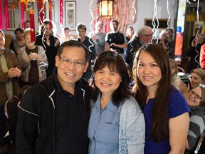 From left, Thai Tang,  Ellen Luc and their daughter Susan Tang pose for a photo during a farewell party at Happy Garden restaurant, in Edmonton Sept. 27, 2015.