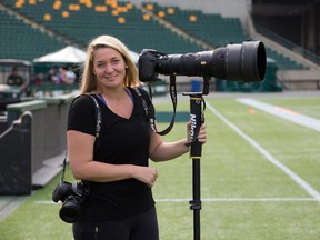 Photographer Johany Jutras during Edmonton Eskimos practice at Commonwealth Stadium in Edmonton on August 26, 2015. Jutras is travelling across Canada to photograph CFL players and fans for a photo book.