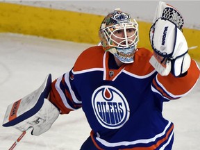 FILE - Ben Scrivens makes a save as the Edmonton Oilers battle the Florida Panthers at Rexall place in Edmonton, Jan. 11, 2015.