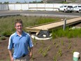 Ross Bulat, Environmental Engineer with the City of Edmonton poses for a photo in the parking lot of the City of Edmonton Drainage Services Eastgate Building in Edmonton on July 9, 2015. An experimental drainage pond has been built in the centre of the parking lot to allow rain water to soak into the ground, fill the pond and support plant life rather than draining directly into the sewer.