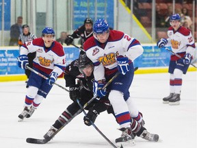 Kyle Yewchuk (2) of the Edmonton Oil Kings battles for the puck with Jack McClelland (24) of the Red Deer Rebels during their first pre-season game held at Servus Place Credit Union arena in St. Albert during on Sept. 5, 2015.